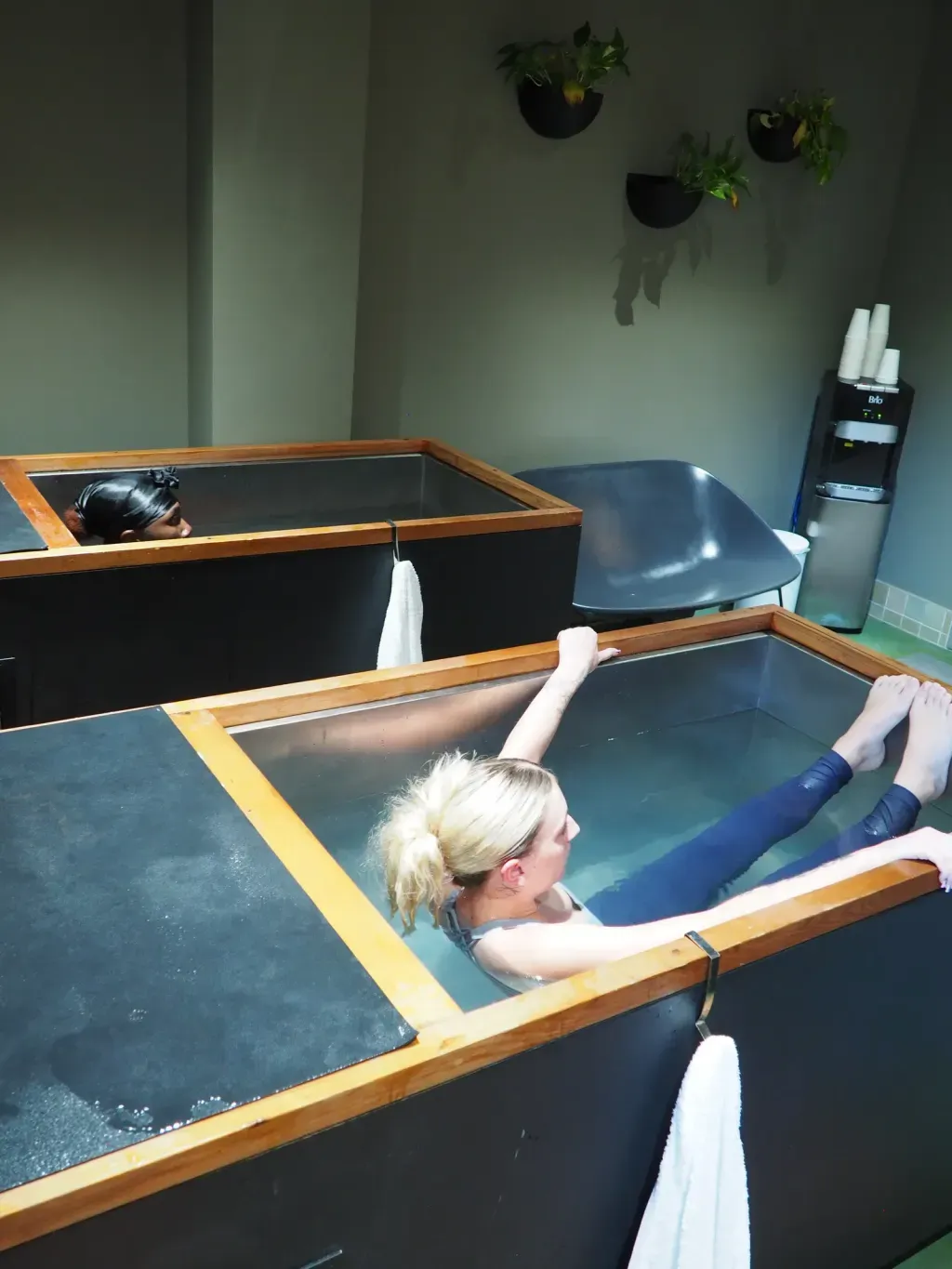 Friends in adjacent individual cold plunges at Sauna Culture Charlotte's Cotswold studio