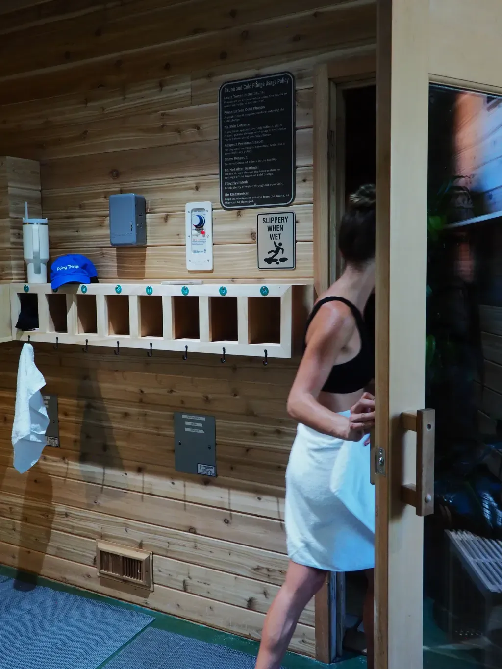 Guest stepping into the Finnish sauna room at Sauna Culture in Cotswold, Charlotte