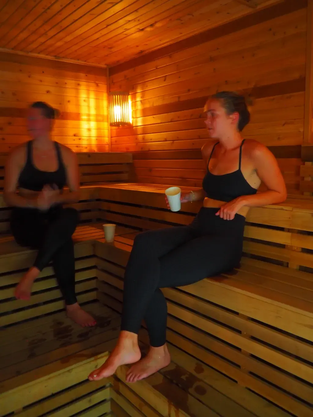 Friends gathered on the upper bench of the Finnish sauna at Sauna Culture in Charlotte